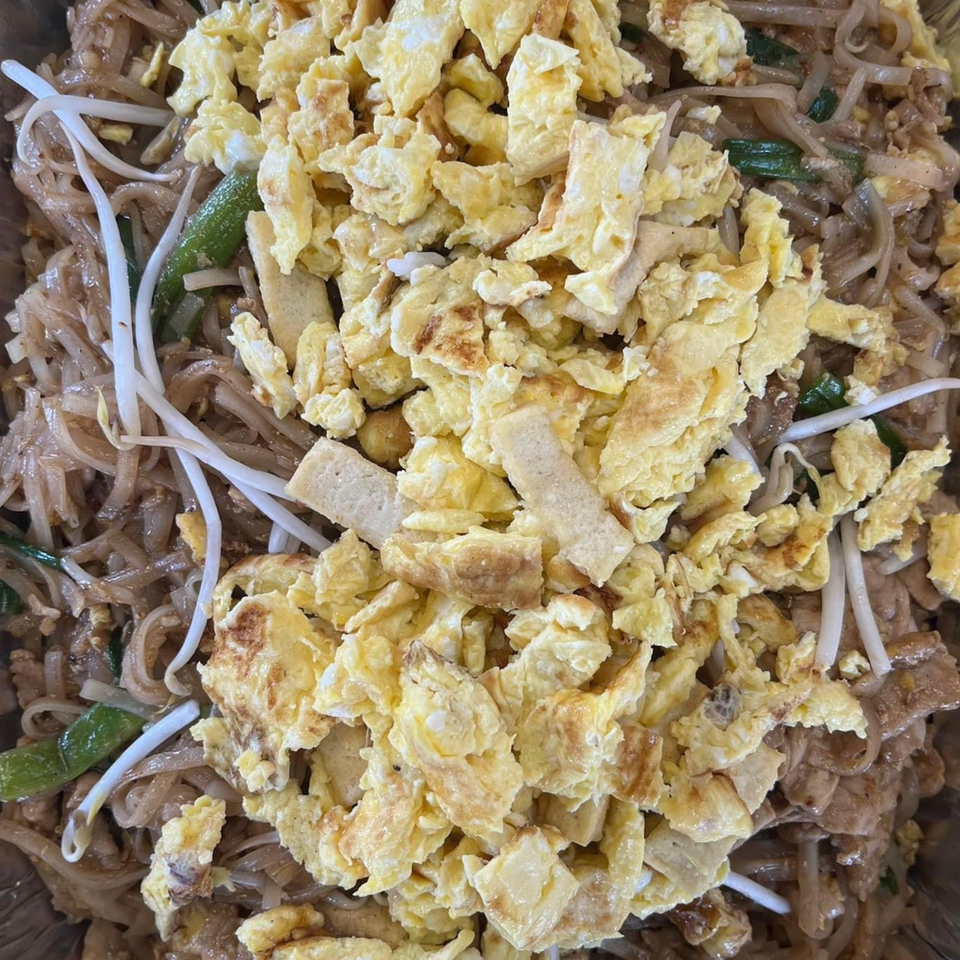 Close-up of Yum Thai's Pad See Ew with wide noodles, bean sprouts, green onions, and scrambled egg.